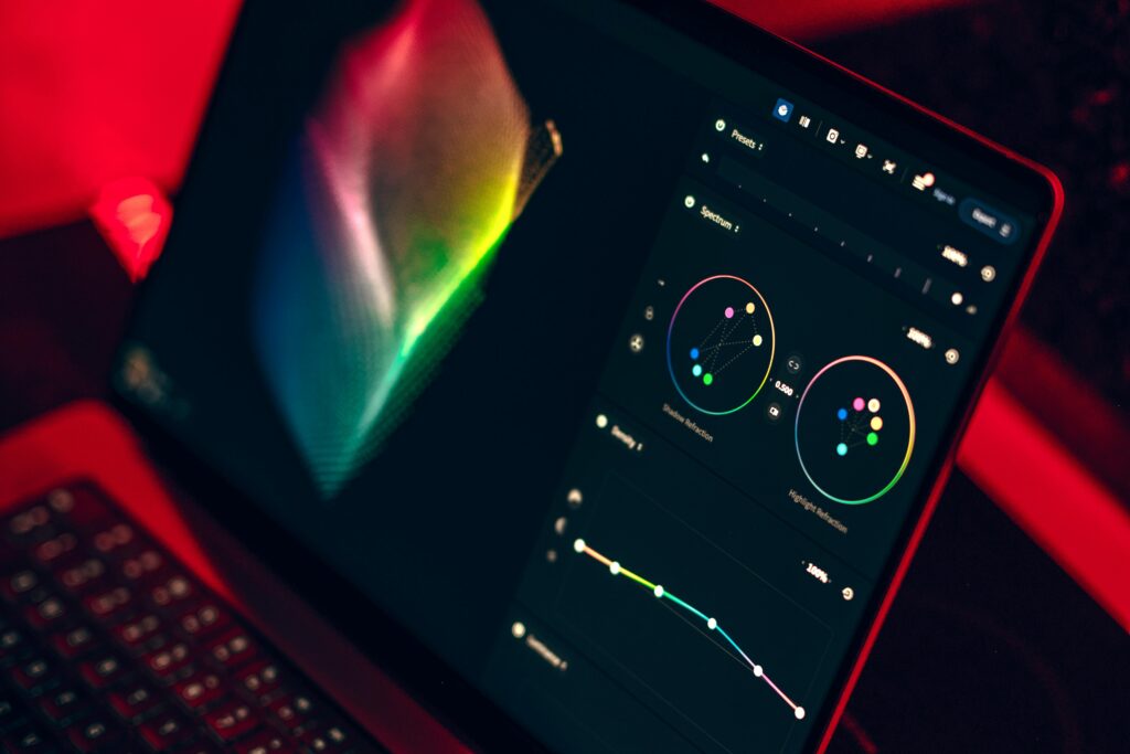 A close-up shot of a laptop displaying a color grading dashboard with vibrant colors.